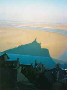 Mont Saint Michel sits on an island with a view, and is surrounded by mudflats