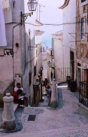 Climg the steep streets of the Alfama in Lisbon